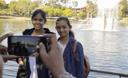 Harini (L) and Abinaya getting their photo taken in front of the UQ lakes. Harini (L) and Abinaya getting their photo taken in front of the UQ lakes.